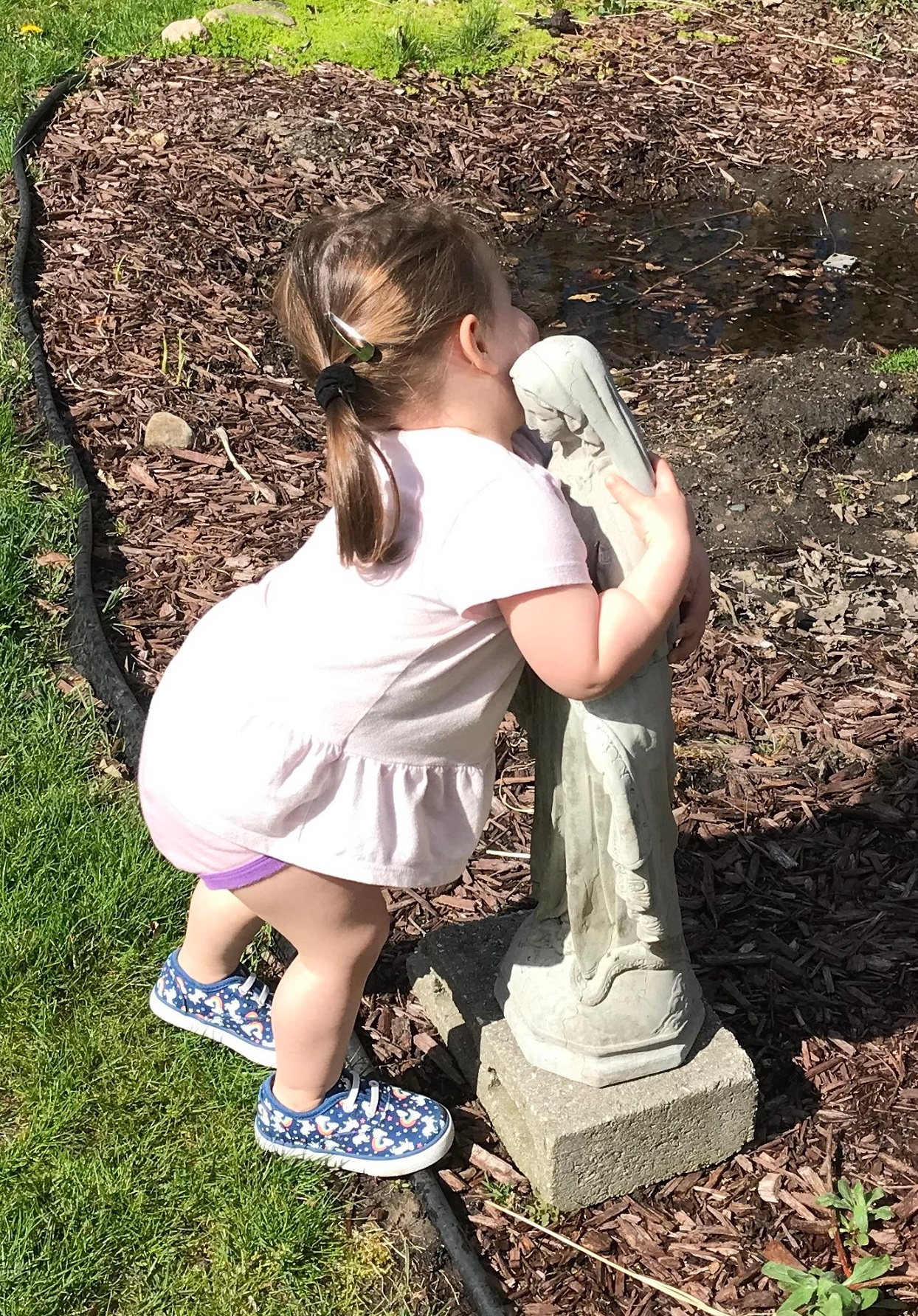 Child hugging Mary Statue